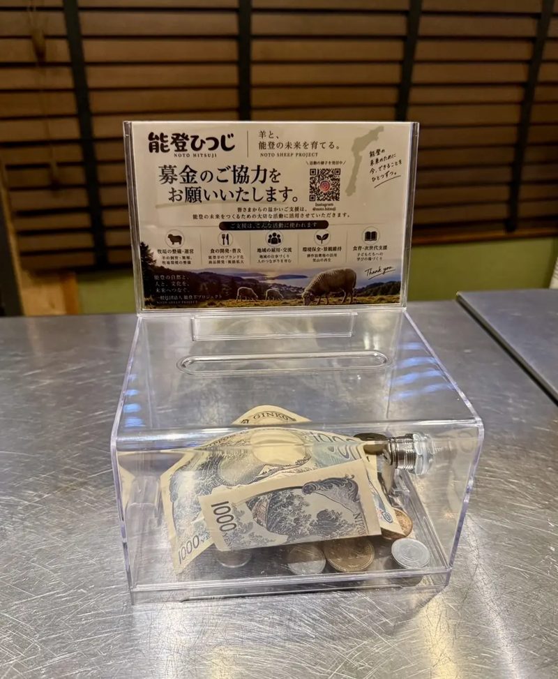 店舗に設置された能登ひつじの募金箱